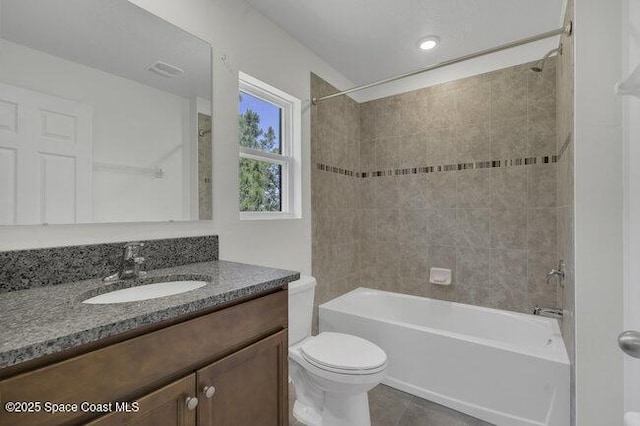 bathroom featuring vanity, tile patterned floors, bathtub / shower combination, and toilet