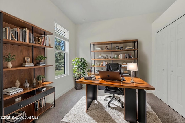 carpeted office space featuring baseboards
