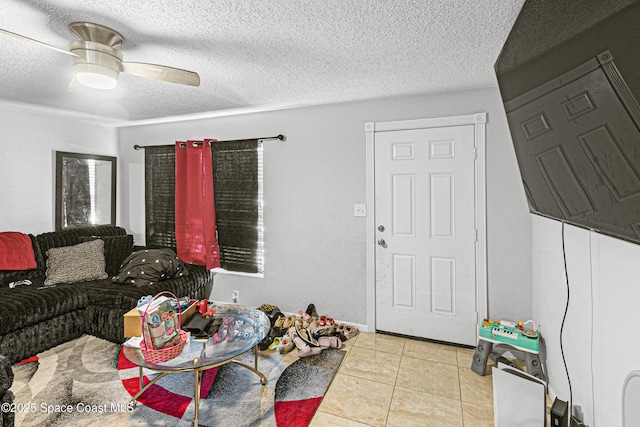 living room with a ceiling fan, tile patterned flooring, and a textured ceiling