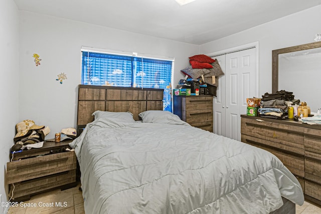 tiled bedroom featuring a closet