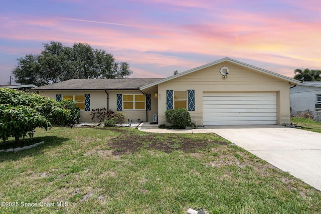 285 Hickory Ave, Merritt Island, FL 32953 - ranch-style house with an attached garage, concrete driveway, a front lawn, and brick siding