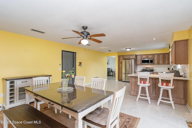 285 Hickory Ave, Merritt Island, FL 32953 - dining space featuring ceiling fan, baseboards, and dark speckled floor