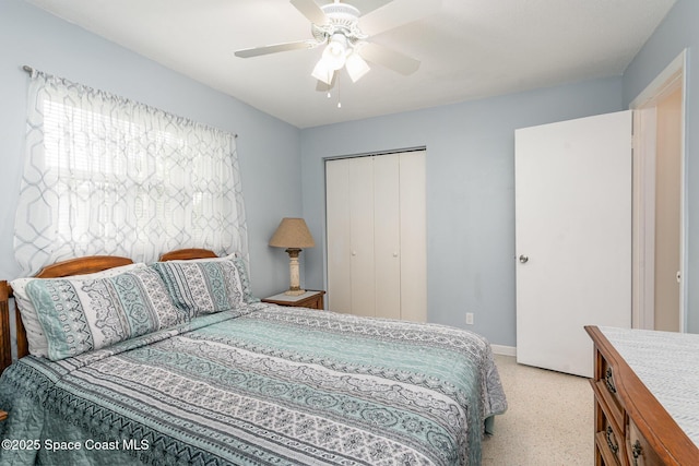 285 Hickory Ave, Merritt Island, FL 32953 - bedroom featuring a closet, a ceiling fan, baseboards, and dark aggregate flooring