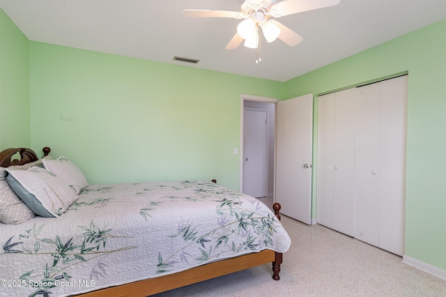 285 Hickory Ave, Merritt Island, FL 32953 - bedroom featuring dark speckled floor, a closet, a ceiling fan, and baseboards