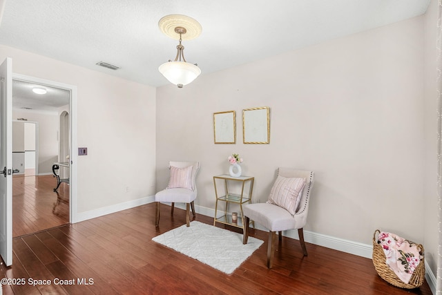 555 Carey Way, Orlando, FL 32825 - sitting room featuring wood-type flooring, baseboards, and arched walkways