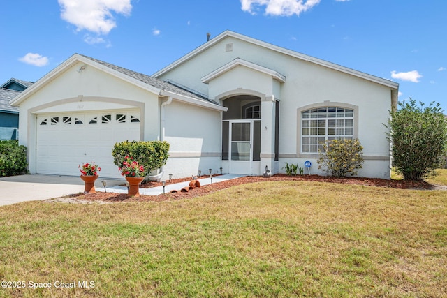 ranch-style home featuring driveway, stucco siding, a garage, and a front yard