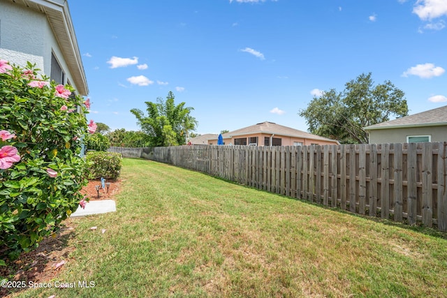 view of yard with a fenced backyard