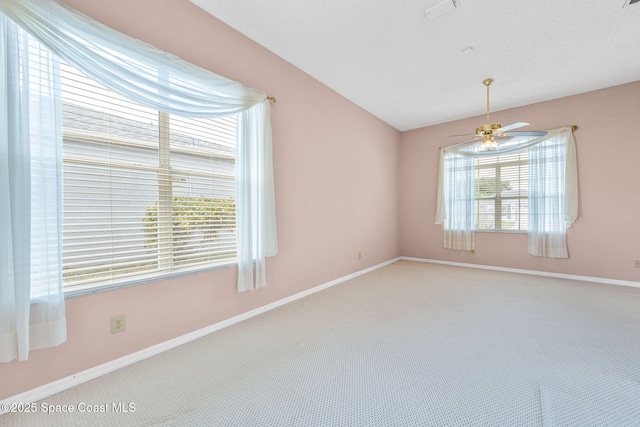 unfurnished room with carpet, a ceiling fan, and plenty of natural light