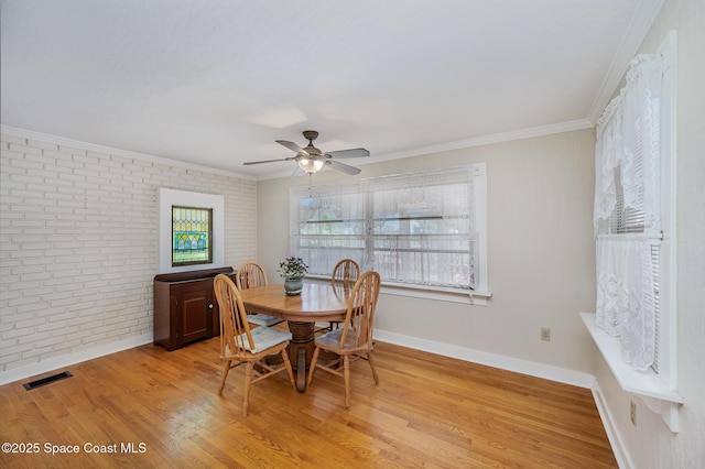 4320 Crooked Mile Rd, Merritt Island, FL 32952 - dining area with light wood-style floors, brick wall, baseboards, visible vents, and ornamental molding