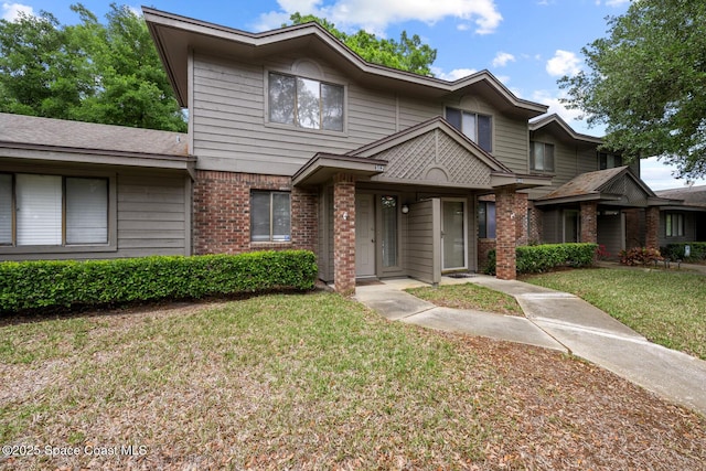 1909 S University Blvd Unit 302, Jacksonville, FL 32216 - townhome / multi-family property with brick siding and a front yard