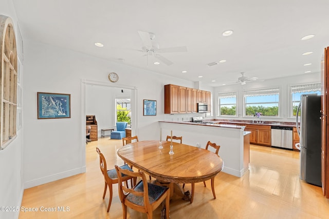 dining space with recessed lighting, light wood finished floors, ceiling fan, and baseboards