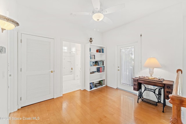 foyer featuring ceiling fan and wood finished floors