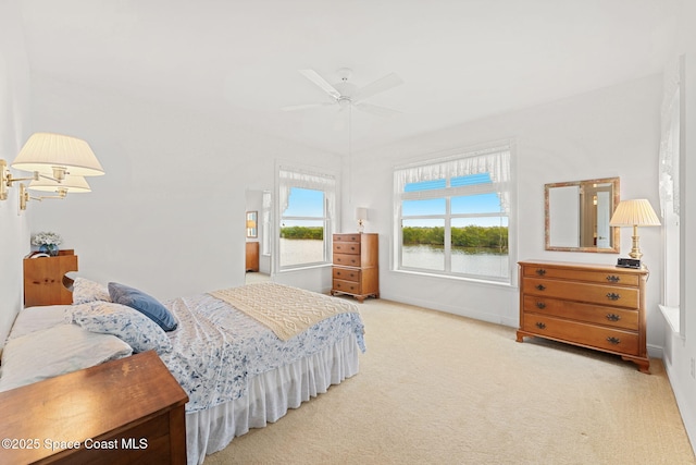 carpeted bedroom with baseboards and a ceiling fan