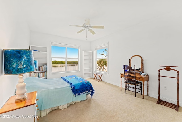 carpeted bedroom with baseboards and ceiling fan