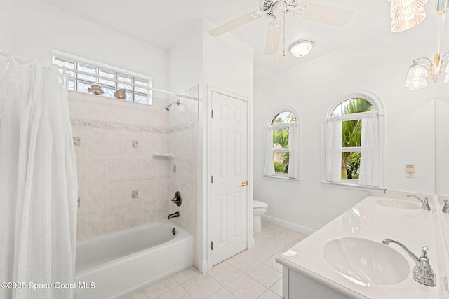 bathroom featuring tile patterned flooring, a sink, a wealth of natural light, and toilet