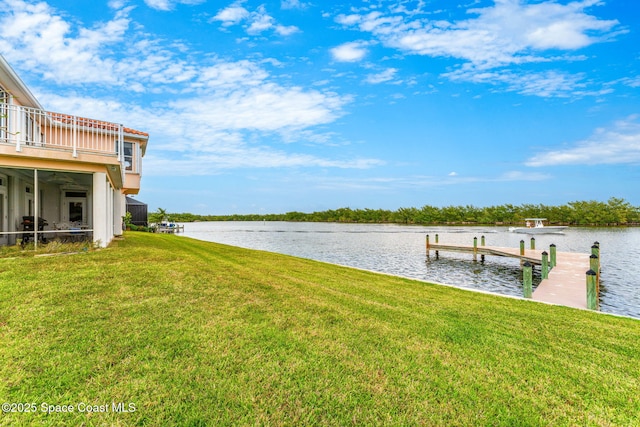 dock area with a water view, a balcony, and a yard