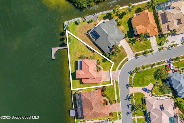 drone / aerial view featuring a water view and a residential view