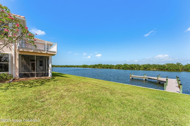 view of dock with a lawn, a water view, and a balcony