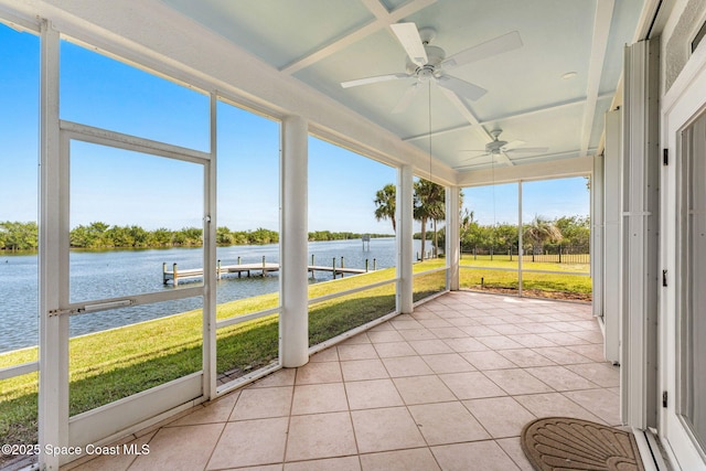 unfurnished sunroom with a water view and ceiling fan