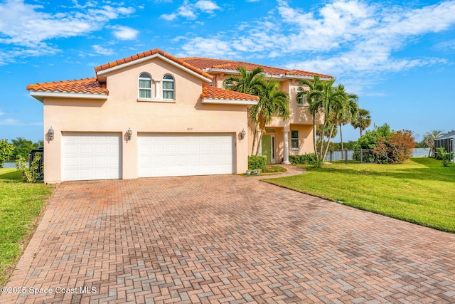 1947 Sykes Creek Dr, Merritt Island, FL 32953 - mediterranean / spanish-style house featuring a tiled roof, decorative driveway, a front yard, and stucco siding