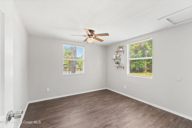 unfurnished room featuring a ceiling fan, baseboards, and wood finished floors