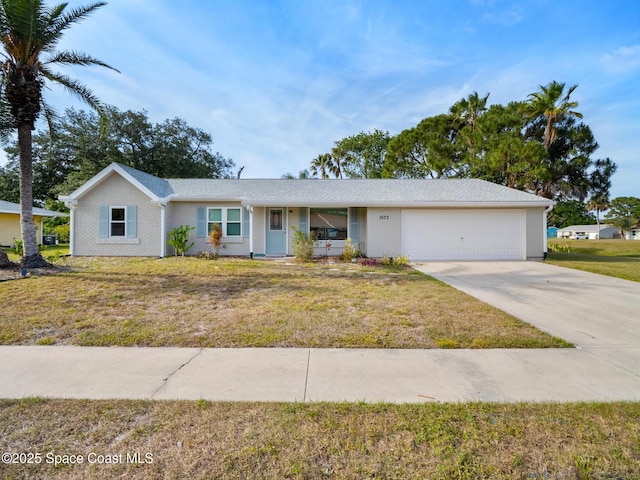 ranch-style home with a front yard, concrete driveway, and a garage