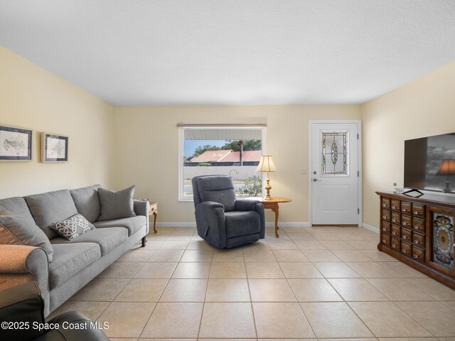 living room featuring light tile patterned flooring and baseboards