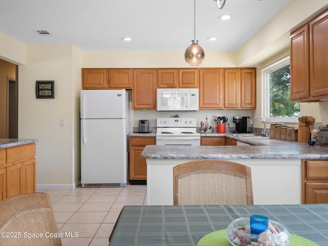 kitchen with light tile patterned floors, a sink, light countertops, recessed lighting, and white appliances