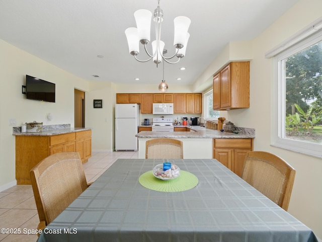 dining space with recessed lighting, light tile patterned flooring, a notable chandelier, and baseboards