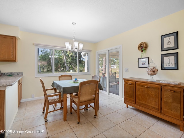 dining space featuring a wealth of natural light, a chandelier, and light tile patterned flooring