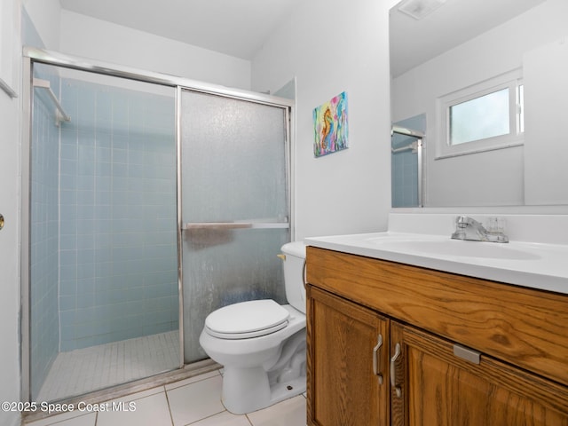 bathroom with a stall shower, toilet, tile patterned flooring, and vanity