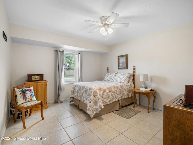 bedroom with light tile patterned floors, a ceiling fan, and baseboards