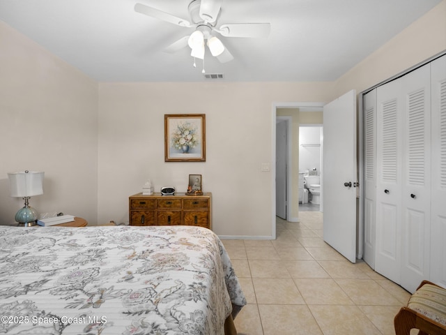 bedroom featuring light tile patterned floors, a closet, ceiling fan, baseboards, and visible vents