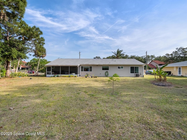 back of house with a yard and a sunroom