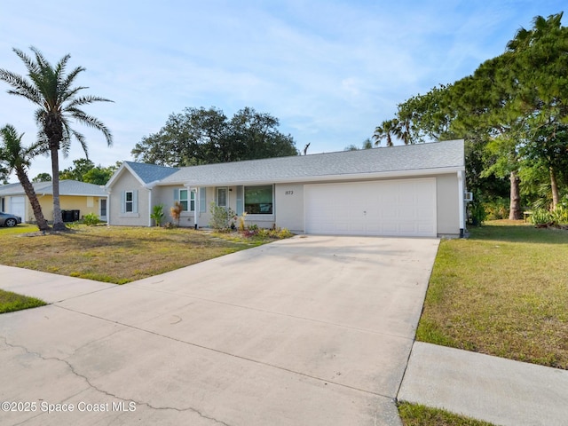 ranch-style house featuring a front yard, concrete driveway, and an attached garage