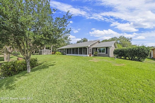101 Joy Haven Dr, Sebastian, FL 32958 - back of property featuring an outdoor structure, a sunroom, a lawn, and a shed