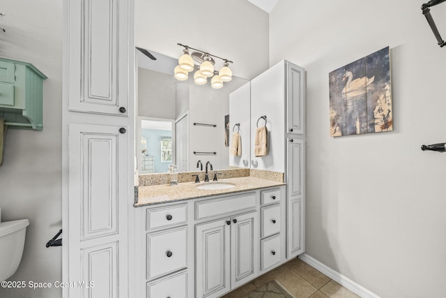 101 Joy Haven Dr, Sebastian, FL 32958 - bathroom with toilet, vanity, tile patterned flooring, and baseboards