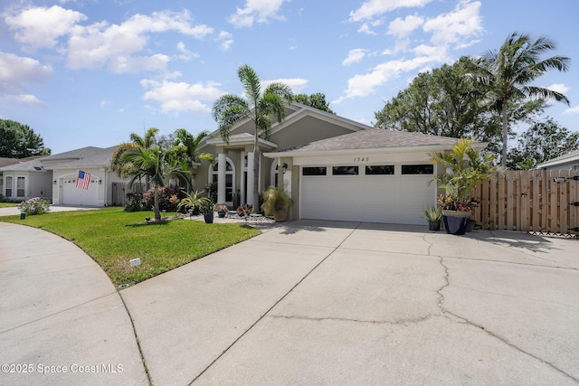 ranch-style house with a front lawn, concrete driveway, fence, a garage, and stucco siding