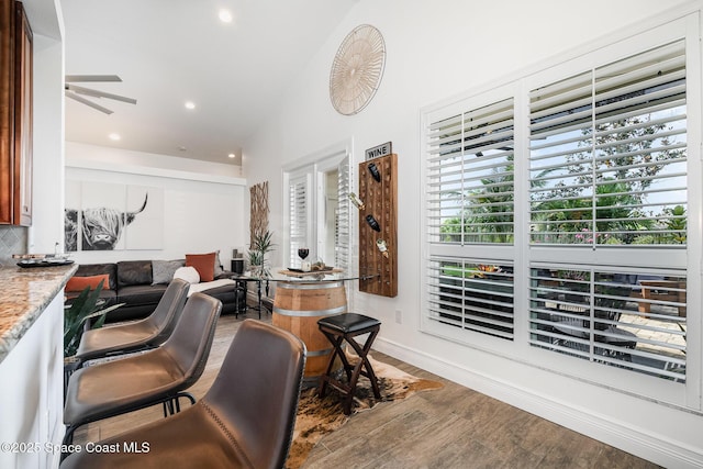 living area with wood finished floors, a wealth of natural light, recessed lighting, and ceiling fan