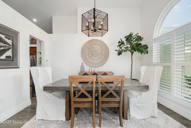 dining space with a chandelier, a wealth of natural light, and dark wood-style floors