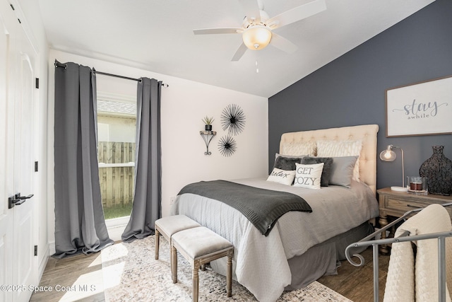 bedroom with vaulted ceiling, wood finished floors, and a ceiling fan