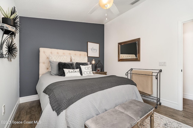 bedroom featuring baseboards, a ceiling fan, wood finished floors, and visible vents