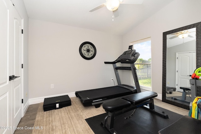exercise area with baseboards, a ceiling fan, and lofted ceiling