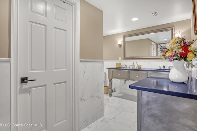 bathroom with visible vents, a wainscoted wall, vanity, and marble finish floor