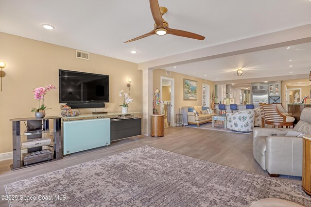living room with recessed lighting, a ceiling fan, visible vents, and wood finished floors