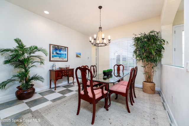 dining space with recessed lighting, a notable chandelier, baseboards, and light floors