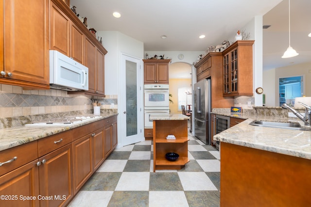kitchen with a sink, open shelves, dark floors, white appliances, and beverage cooler