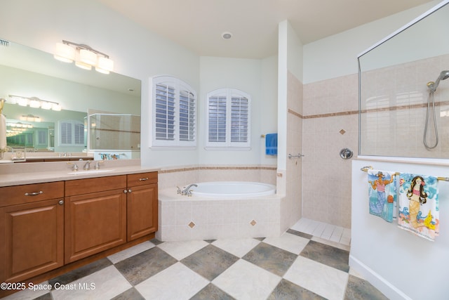 full bathroom featuring a walk in shower, vanity, a bath, and tile patterned flooring