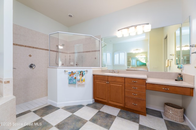 bathroom with a walk in shower, tile patterned flooring, and vanity