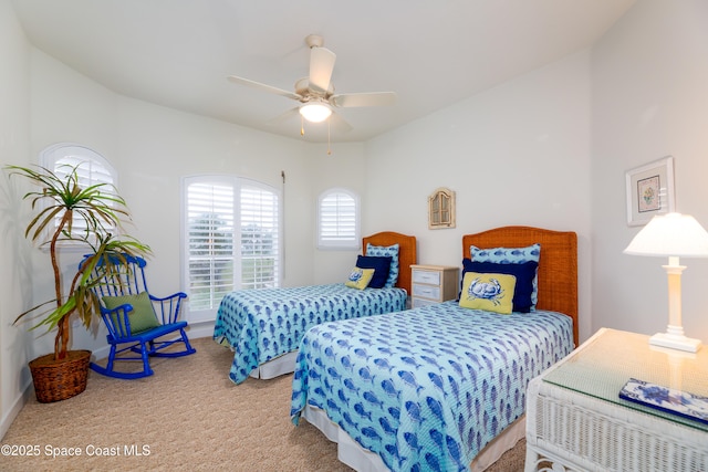 bedroom with ceiling fan, baseboards, and carpet floors